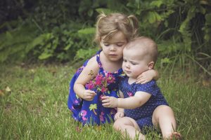 sisters looking at flowers