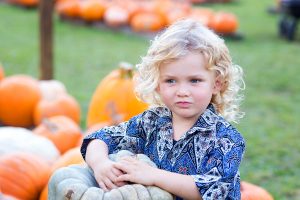 portrait of child in pumpkin patch