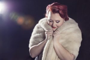 woman photographed in studio with fur coat