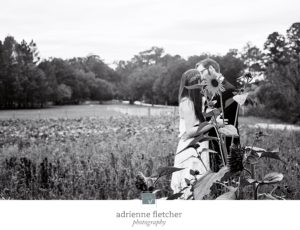 couple kissing behind sunflower