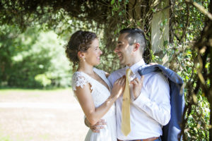 bride and groom under archway