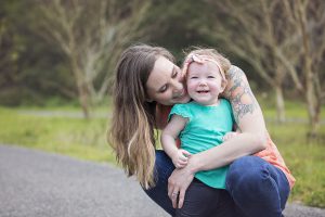 mom hugging daughter outside