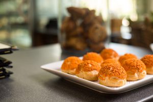 close up of cream puffs in a bakery