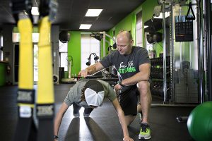 trainer in gym training client