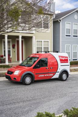 AC repair truck in front of house