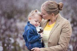 motehr holding daughter in cotton field