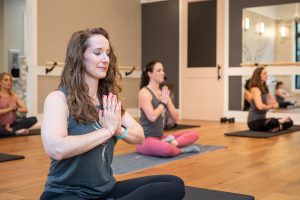 women meditating in a barre fitness class for branding images